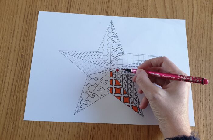 Carefully color each part of the star with coloring markers.